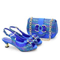 Blue high-heeled shoes and matching handbag with decorative elements on a white background, Obroi