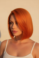 Orange wig on a mannequin head and close-up view of the hair strands, Obroi