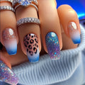 Nails with gradient and pattern designs, featuring rings on a neutral background, Obroi