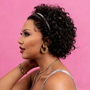 Woman with styled hair and jewelry against a pink background, Obroi