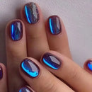 Hand with blue metallic nail polish on a plain background, Obroi