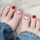  toes with red and gold polka dot nail design