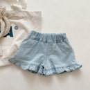 Light blue denim shorts with ruffled edges on a light background, Obroi