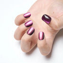 Hand with purple metallic nail polish on a white background, Obroi