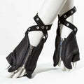 Black fingerless gloves with silver metal zippers, wrap-around straps, and silver grommets, displayed on a white mannequin foot and lower leg against a white studio background, Obroi