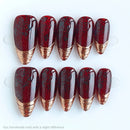Set of red and gold nail tips on a white background, Obroi