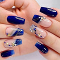 Hand with blue and white nail art on a neutral background, Obroi