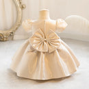 Beige dress with a large bow on a mannequin against a neutral background, Obroi