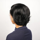 Person with styled black hair wearing a navy blue garment on a white background, Obroi