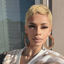 Woman with short blonde hair wearing large hoop earrings outdoors, Obroi