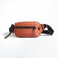 Orange waist bag with black strap on a white background, Obroi