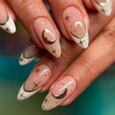 Nails with gold and black designs on a blurred background, Obroi