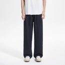 Person wearing black wide-leg pants and a white top on a white background, Obroi