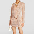 Beige embroidered blazer worn by a person on a light gray background, Obroi
