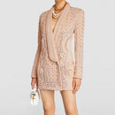 Beige embroidered blazer worn by a person on a light gray background, Obroi