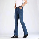 Person wearing blue jeans and black shoes on a white background, Obroi