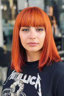 Side-by-side comparison of a person with orange hair and a mannequin head with orange hair, Obroi