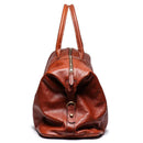 Brown leather duffel bag with gold zipper and buckle on a white background, Obroi