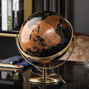 Decorative globe with a gold stand on a desk