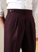 Maroon pleated pants worn with a white shirt on a neutral background, Obroi