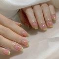 Close-up of hands with pink and green nail polish on a white fabric background, Obroi