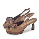A pair of women's metallic bronze slingback heels with textured snakeskin-patterned bow details on the front and a chunky block heel, shown on a white background, Obroi