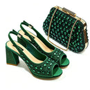 A matching green embellished women's outfit set featuring a pair of peep-toe slingback high heels and a structured clutch handbag with a gold chain strap, displayed on a clean white background, Obroi