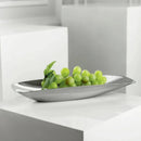 Silver bowl with green grapes on a white surface, Obroi