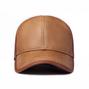 A structured baseball cap made of textured tan leather, shown from the front on a solid white background, Obroi