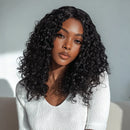 Woman with curly black hair wearing a light gray sweater against a neutral background, Obroi
