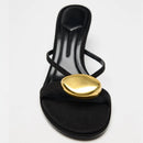 Black sandal with a gold embellishment on a white background, Obroi