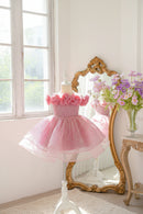 Pink dress with floral details on a mannequin in a bright room, Obroi