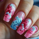 Nails with pink and blue design on a blurred background