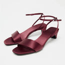 Maroon sandals with thin straps on a light gray background, Obroi