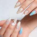 Hand with decorative nails featuring a mix of colors and designs on a light background, Obroi