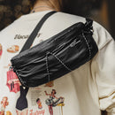 Black leather waist bag worn by a person with a graphic design on their clothing, Obroi