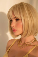 Blonde bob wig with straight bangs, shown on a model, on a mannequin bust, and from a top-down view showing the part, with a comb visible in one panel, Obroi