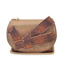 A metallic bronze mesh clutch bag featuring a large, wide decorative bow embellished with shimmering brown and copper rhinestones, finished with a gold-tone chain strap on a plain white background, Obroi
