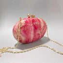 Pink and gold handbag with a chain strap on a light gray background, Obroi
