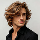 Man with styled hair wearing a black shirt against a plain background, Obroi