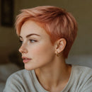 Woman with short pink hair wearing a gold hoop earring, Obroi