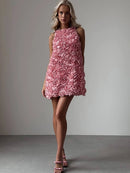 Woman wearing a pink floral dress against a plain background, Obroi