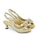 Gold high-heeled shoes with decorative bows and crystals on a white background, Obroi