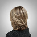 Person with styled hair in a salon setting, Obroi