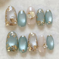 Nail art with gold leaf and pearl decorations on a light background, Obroi