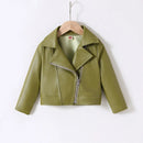 A children's cropped moto jacket in olive green faux leather, hanging on a wooden hanger against a plain white background, Obroi