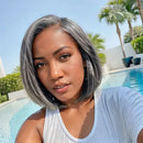 Woman with gray hair by a pool with palm trees in the background, Obroi