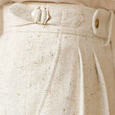 Close-up of a textured beige fabric with buttons on a beige background, Obroi