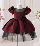 Red and black floral dress on a mannequin with a white background obroi