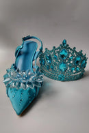 Turquoise high-heeled shoes and matching handbag with crystal embellishments on a gray background, Obroi